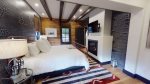 Rustic design guest bedroom with gas fireplace